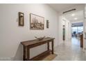 Bright entryway with rustic console table and southwestern art at 19930 W Exeter Blvd, Litchfield Park, AZ 85340