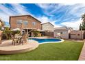 Large kidney-shaped pool, spacious backyard, and home at 30084 N Desert Willow Blvd, San Tan Valley, AZ 85143