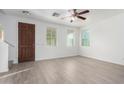 Bright living room featuring wood-look floors, ceiling fan, and natural light from the many windows at 4044 E Oakland St, Gilbert, AZ 85295