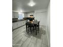 Kitchen dining area with tile floor and modern appliances at 4124 N 105Th Ln, Phoenix, AZ 85037