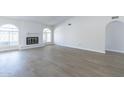 Bright living room with fireplace and laminate floors at 4202 W Wood Dr, Phoenix, AZ 85029