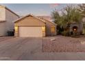 Tan house with two-car garage and desert landscaping at 4322 E South Fork Dr, Phoenix, AZ 85044