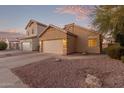 Tan house with two-car garage and desert landscaping at 4322 E South Fork Dr, Phoenix, AZ 85044