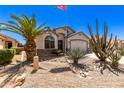 Landscaped front yard with desert plants and a flag at 45579 W Rainbow Dr, Maricopa, AZ 85139