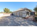 Three-car garage with ample parking space and additional storage at 5432 W Fallen Leaf Ln, Glendale, AZ 85310