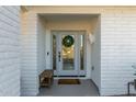 Modern front door with glass panels and a wood bench at 7489 E Windrose Dr, Scottsdale, AZ 85260