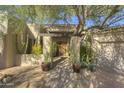 Inviting entryway with a wooden door and pathway leading to the home at 7546 E High Point Dr, Scottsdale, AZ 85266