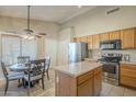 Eat-in kitchen with stainless steel appliances and an island at 896 E Windsor Dr, Gilbert, AZ 85296