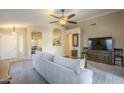 Spacious living room with a neutral color palette and large TV at 896 E Windsor Dr, Gilbert, AZ 85296