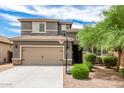 Two-story house with a two-car garage and landscaped yard at 1081 W Danish Red Trl, San Tan Valley, AZ 85143