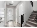 Bright entryway with tile flooring, modern door, and staircase at 1110 S Jay St, Chandler, AZ 85286