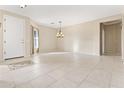 Open living area with a tile entry, neutral walls, and modern chandelier at 1242 E Bartlett Way, Chandler, AZ 85249