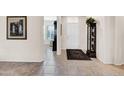 Interior entryway with tile flooring and display cabinet at 15506 W Skyview Way, Surprise, AZ 85374