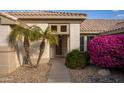 Front entrance with double palm trees and walkway at 15506 W Skyview Way, Surprise, AZ 85374