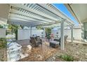 Relaxing patio with pergola, seating area, and fire pit at 18852 N Aztec Dr, Sun City, AZ 85373