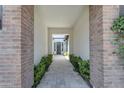 Brick pillars frame a walkway leading to the front door, enhancing curb appeal at 21961 E Via De Arboles St, Queen Creek, AZ 85142