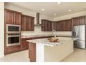 Island kitchen with granite countertops and stainless steel appliances at 22665 E Stacey Rd, Queen Creek, AZ 85142