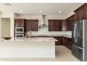 Spacious kitchen with granite countertops, dark wood cabinets, and stainless steel appliances at 22665 E Stacey Rd, Queen Creek, AZ 85142