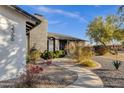 Landscaped walkway leading to the front entrance of a mid-century modern home at 2366 E Becker Ln, Phoenix, AZ 85028