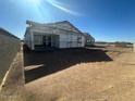 Unfinished home's rear elevation showcasing the patio and surrounding area at 2446 E Spur Dr, San Tan Valley, AZ 85140