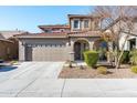 Two-story house with tan siding, brown roof, and a two-car garage at 25210 N 54Th Dr, Phoenix, AZ 85083