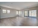 Spacious living room with sliding glass doors and wood-look tile floors at 2732 N 217Th Ave, Buckeye, AZ 85396