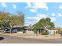 Mid-century home with solar panels, driveway and landscaped yard at 3105 N 21St St, Phoenix, AZ 85016