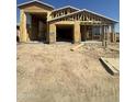 New construction home with a framing of the exterior, showcasing a multi-car garage and architectural design at 32189 N Lone Rancher Way, San Tan Valley, AZ 85140