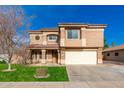 Two story house with a large driveway and grassy lawn at 3552 E Claxton Ave, Gilbert, AZ 85297