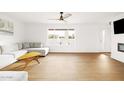 Bright and airy living room with light wood floors and a modern fireplace at 3810 E Shea Blvd, Phoenix, AZ 85028