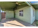 Covered patio entrance with a light green brick wall at 3821 W Verde Ln, Phoenix, AZ 85019