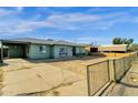 Brick house with carport and a partially fenced yard at 3821 W Verde Ln, Phoenix, AZ 85019