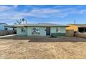 Light green brick ranch house with a spacious yard at 3821 W Verde Ln, Phoenix, AZ 85019