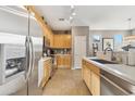 Modern kitchen with stainless steel appliances and light wood cabinets at 4364 E Selena Dr, Phoenix, AZ 85050