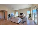 Bright living room with comfortable seating and large windows at 5407 W Windmill Ln, Eloy, AZ 85131