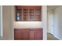 Butlers pantry with glass-front cabinets and quartz countertop at 5407 W Windmill Ln, Eloy, AZ 85131