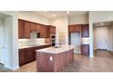 Spacious kitchen with island, stainless steel appliances, and wood cabinets at 5411 W Windmill Ln, Eloy, AZ 85131