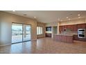 Open concept kitchen with island and access to backyard patio at 5411 W Windmill Ln, Eloy, AZ 85131