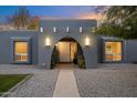 Inviting entryway with arched doorway, stylish lighting, and landscaping at 5429 E Bloomfield Rd, Scottsdale, AZ 85254