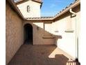 Charming courtyard entry with a brick paved floor and arched entryway at 5450 W Taro Ln, Glendale, AZ 85308