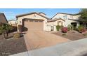 Inviting home with a large driveway and neatly landscaped front yard at 5450 W Taro Ln, Glendale, AZ 85308