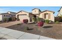 Stunning curb appeal featuring a brick driveway and mature desert landscaping at 5450 W Taro Ln, Glendale, AZ 85308