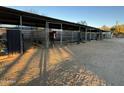 Multiple horse stables with covered areas and feeding troughs at 5638 E Skinner Dr, Cave Creek, AZ 85331