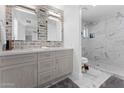 Elegant bathroom with double vanity, brick feature wall, and marble shower at 5717 E Justine Rd, Scottsdale, AZ 85254