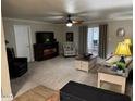 Living room with fireplace, TV, and comfy seating at 5929 E Duncan St, Mesa, AZ 85205