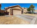 House exterior showcasing stone accents and a two-car garage at 660 N Maple St, Chandler, AZ 85226