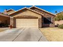 House exterior with stone accents and a two-car garage at 660 N Maple St, Chandler, AZ 85226