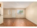 Living room features wood-look floors and a view of the front entrance at 6820 S Rita --, Tempe, AZ 85283