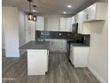 Modern kitchen featuring white cabinets and a large island at 7015 N 23Rd Ln, Phoenix, AZ 85021