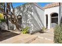 Front entrance with arched entryway and flagstone path at 8008 E Del Rubi Dr, Scottsdale, AZ 85258